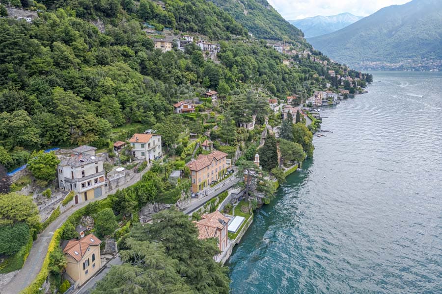 The shore of Lake Como seen from above, with villas right by the water